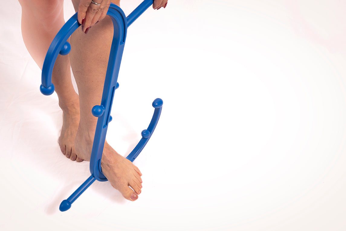 Blue foot stretcher being used on a person's feet against a white background